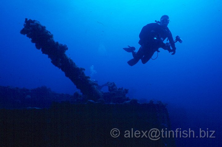 Saratoga Chris J.jpg - Diver beside anti-aircraft gun